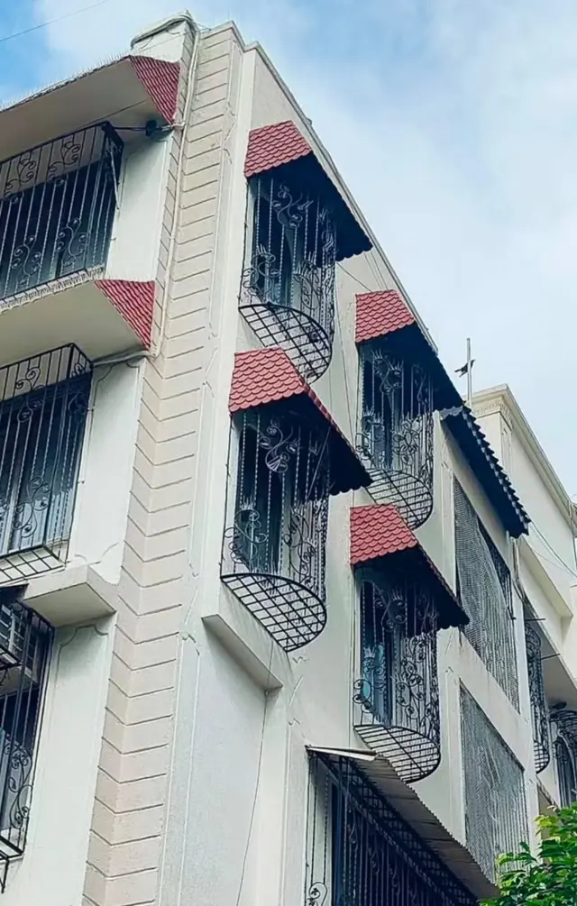 Red tile FRP chajjas on a building